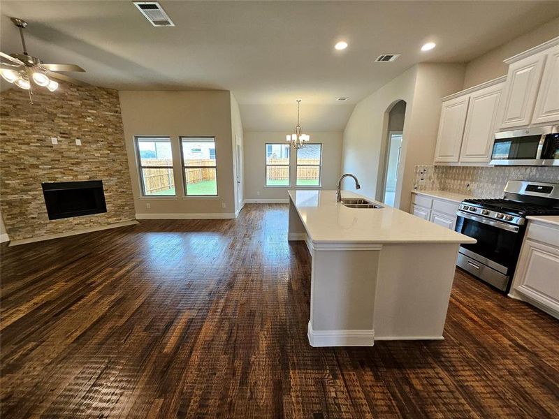 Open great room with rich hardwood floors (fireplace not included)