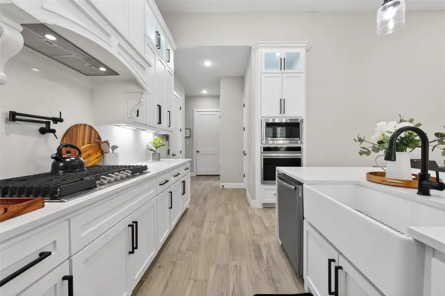 Chef’s kitchen with ample counter space and walk-in pantry access. Chef’s kitchen with ample counter space and walk-in pantry access.