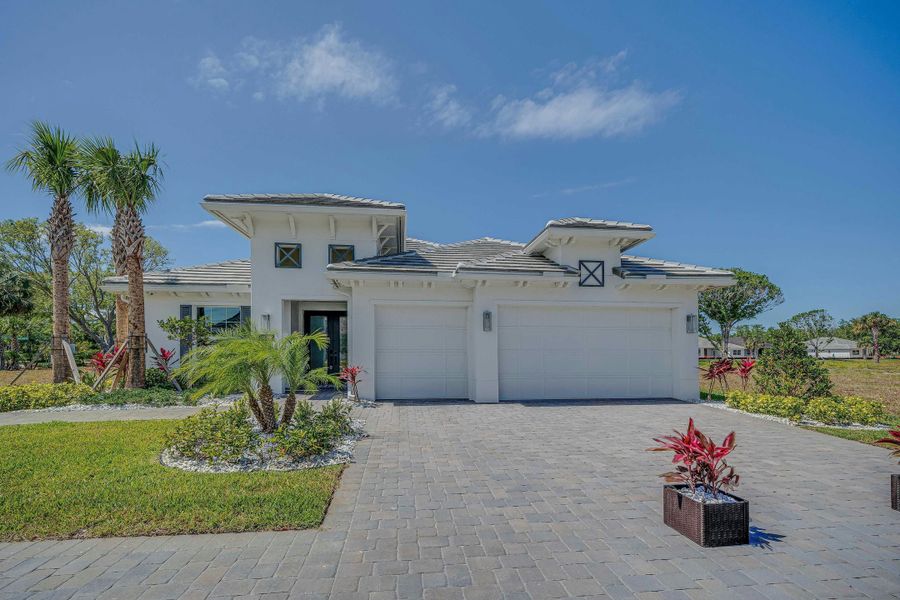 Front exterior of a new home in Lucaya Pointe, Vero Beach, FL, highlighting curb appeal (Image 2).