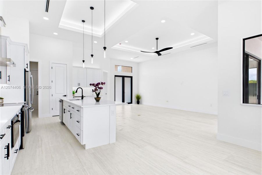 Living, dining, kitchen, and primary suite feature RECESSED CEILINGS accented by sleek LED TRACK lighting. Living, dining, kitchen, and primary suite feature RECESSED CEILINGS accented by sleek LED TRACK lighting.
