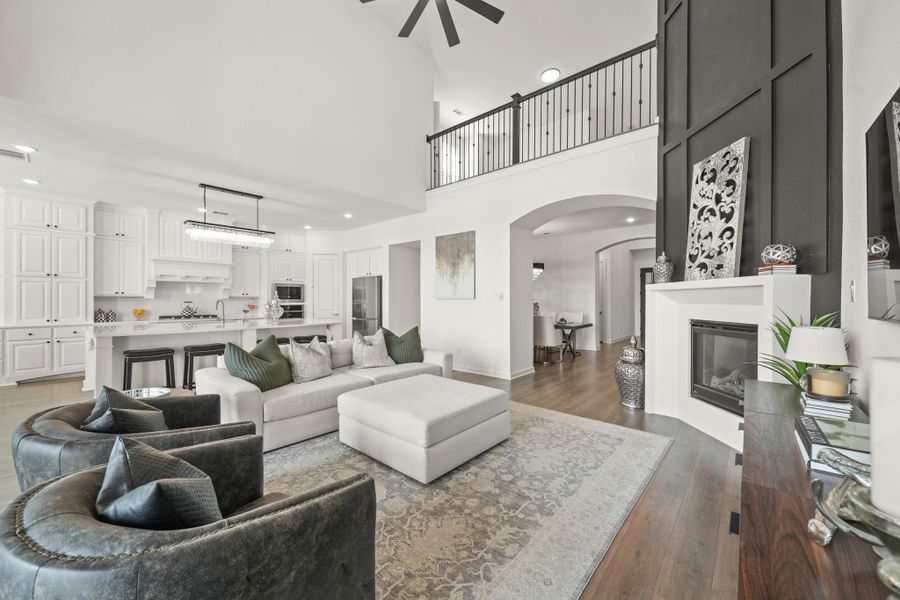 From the living room, enjoy a clear view of the living spaces, creating a layout that works well for everyday living. Notice the balcony views from above with the decorative wrought iron railing.