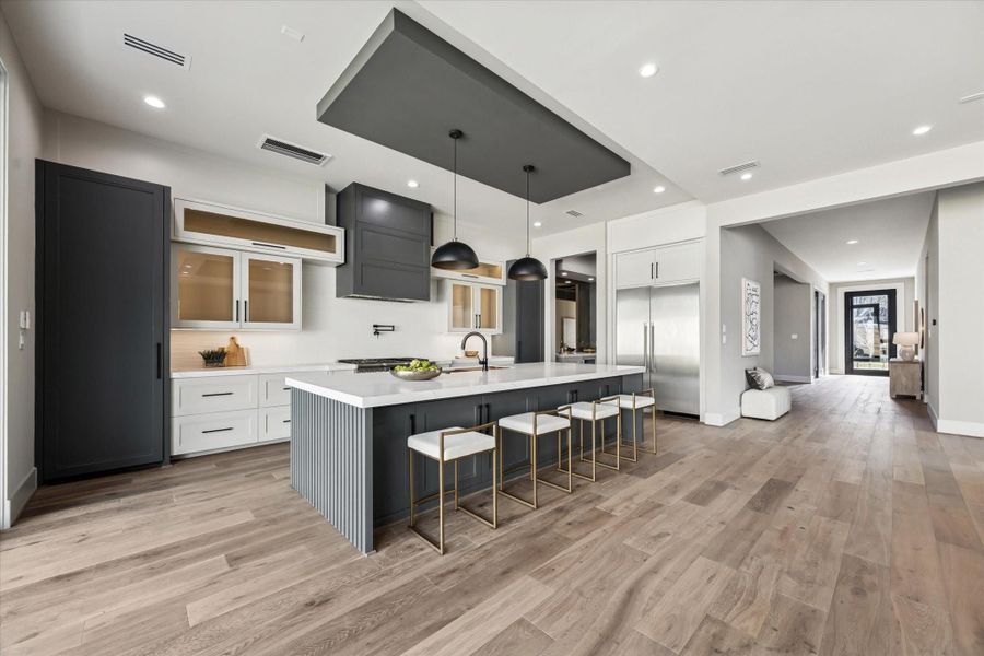 An impressive island serves as the centerpiece of the kitchen, featuring an integrated sink, expansive workspace, and abundant storage. With seating for 5–6, it effortlessly combines functionality and style, creating the perfect hub for both meal preparation and casual gatherings.