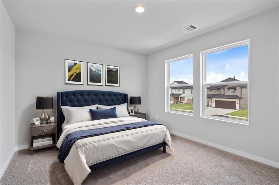 This secondary bedroom features high ceilings, recessed lighting, custom paint, plush carpet, and large window with privacy blinds!