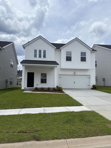 Front exterior of a new home in Sweetgrass at Summers Corner, Summerville, SC, highlighting curb appeal (Image 13).