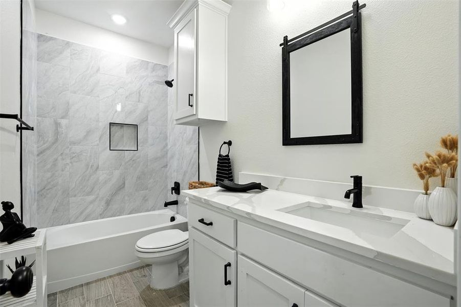 Full bathroom with vanity,  shower combination, and wood tiled floors