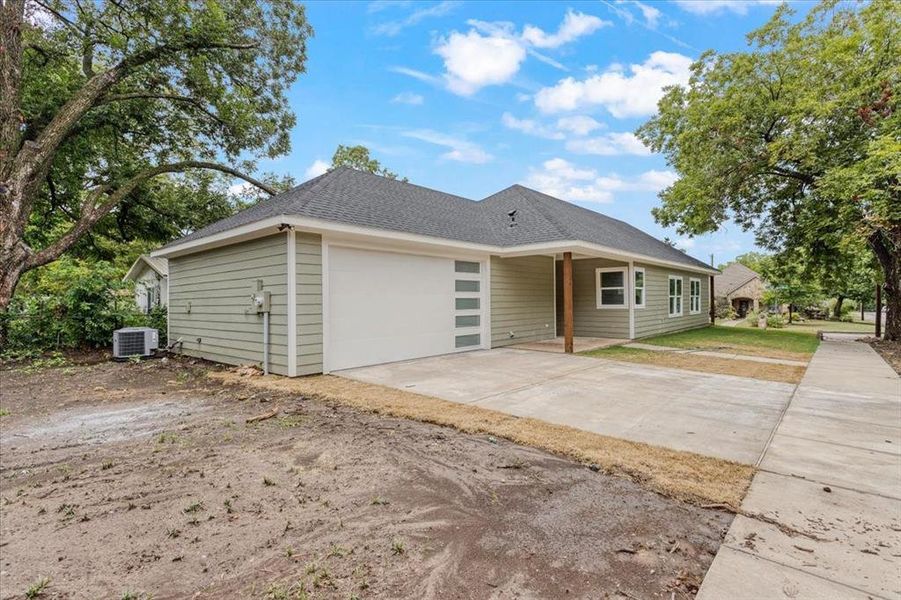 Ranch-style house featuring a garage and cooling unit