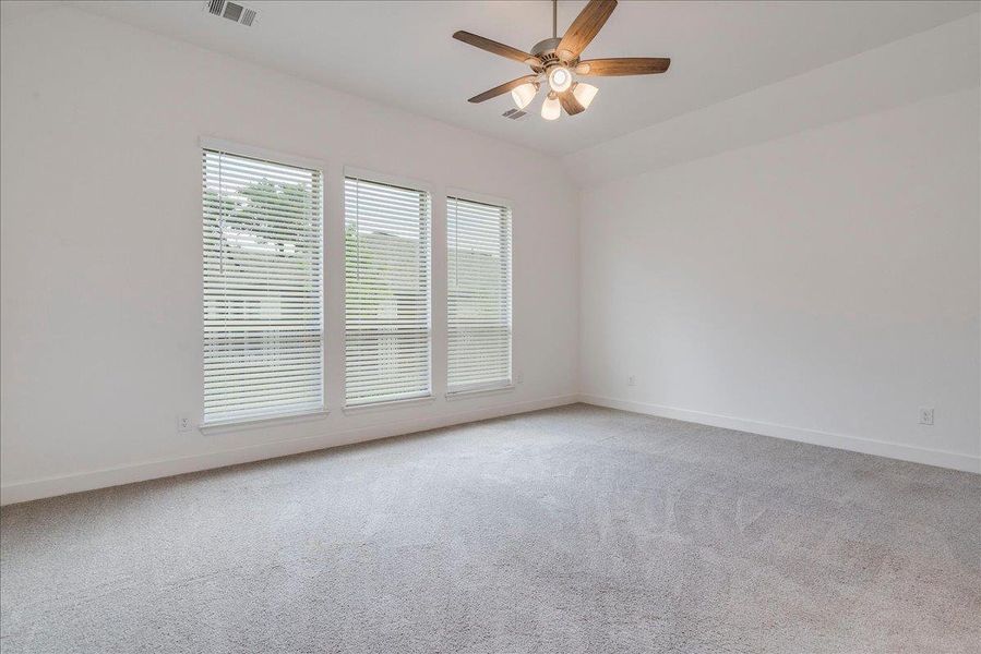 The property features a spacious room with light gray carpeting and white walls