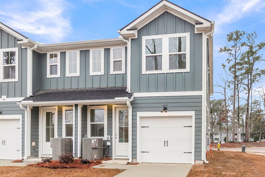 Front exterior of a new home in Windward Village, Summerville, SC, highlighting curb appeal (Image 27). Front exterior of a new home in Windward Village, Summerville, SC, highlighting curb appeal (Image 27).