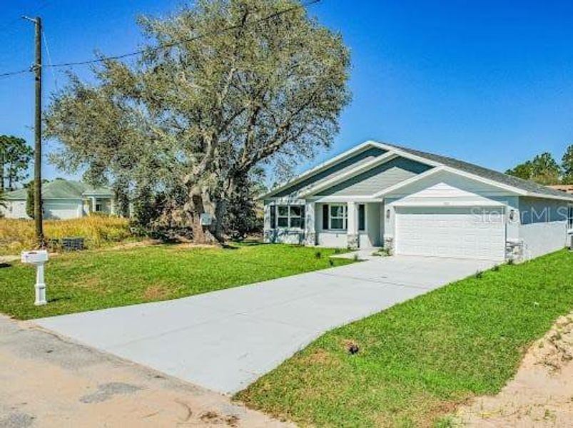 Front exterior of a new home in , Kissimmee, FL, highlighting curb appeal (Image 1). Front exterior of a new home in , Kissimmee, FL, highlighting curb appeal (Image 1).
