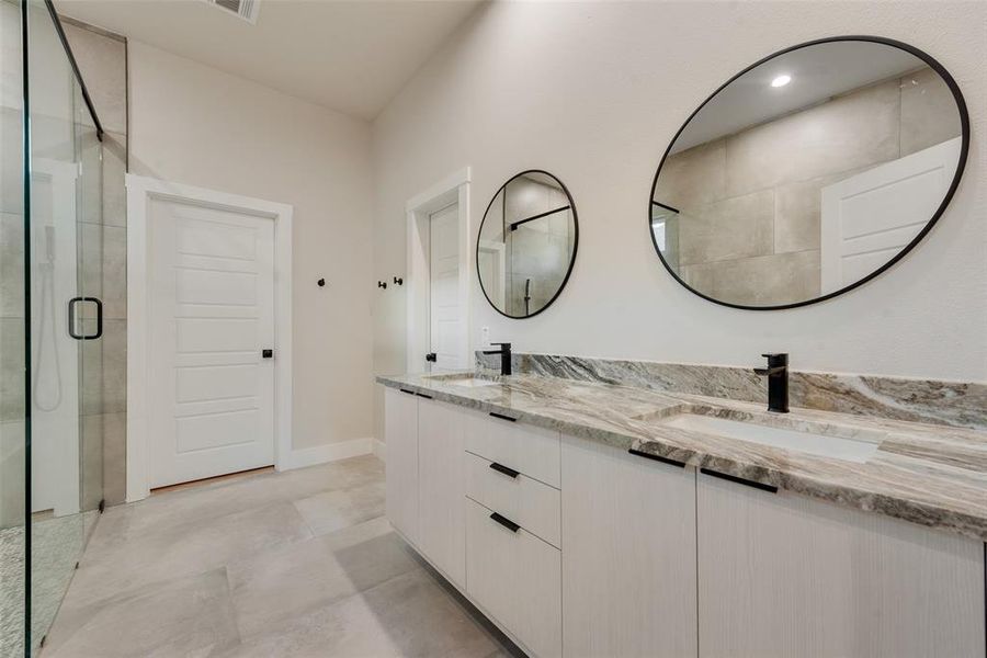 Bathroom with a shower with door and vanity