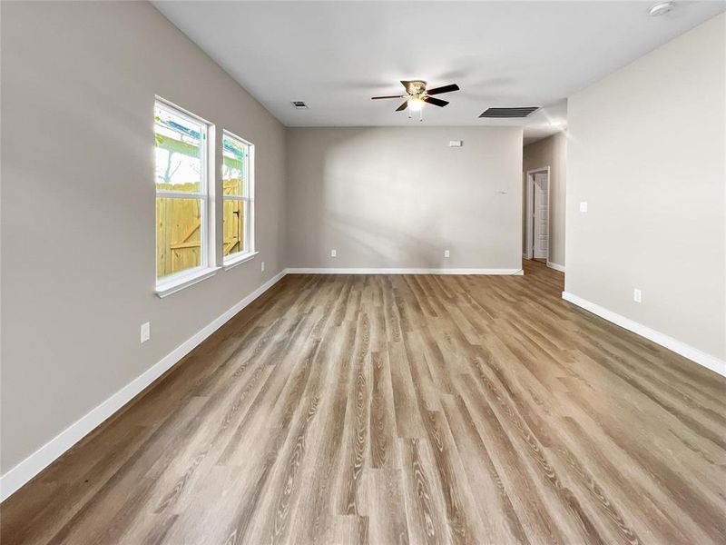 Empty room featuring a ceiling fan and wood finished floors