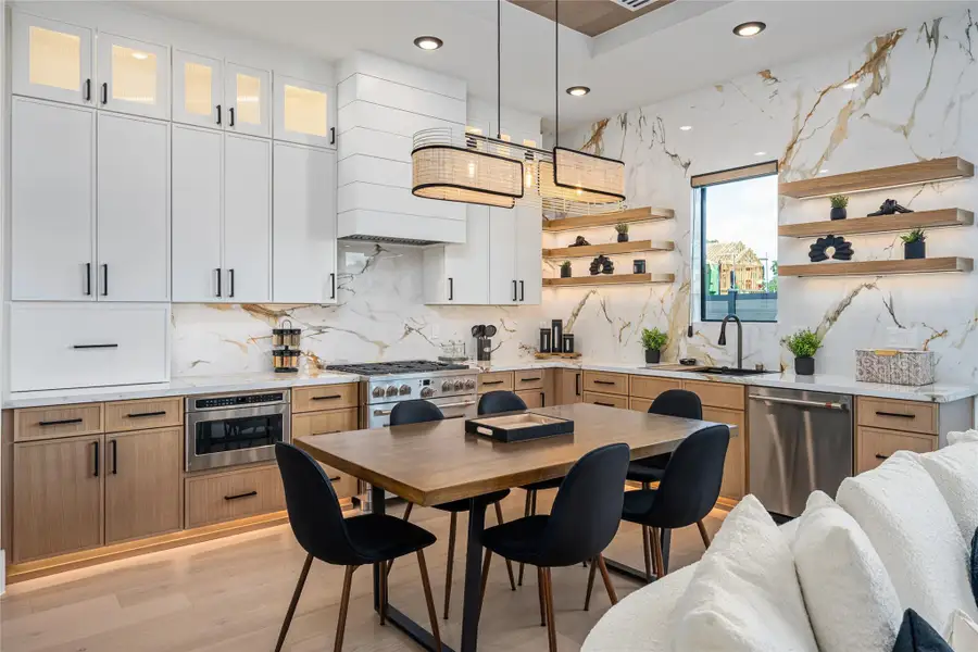 Cabinets soaring to the ceiling, expansive quartz countertops, and generous storage bring beauty and utility together flawlessly