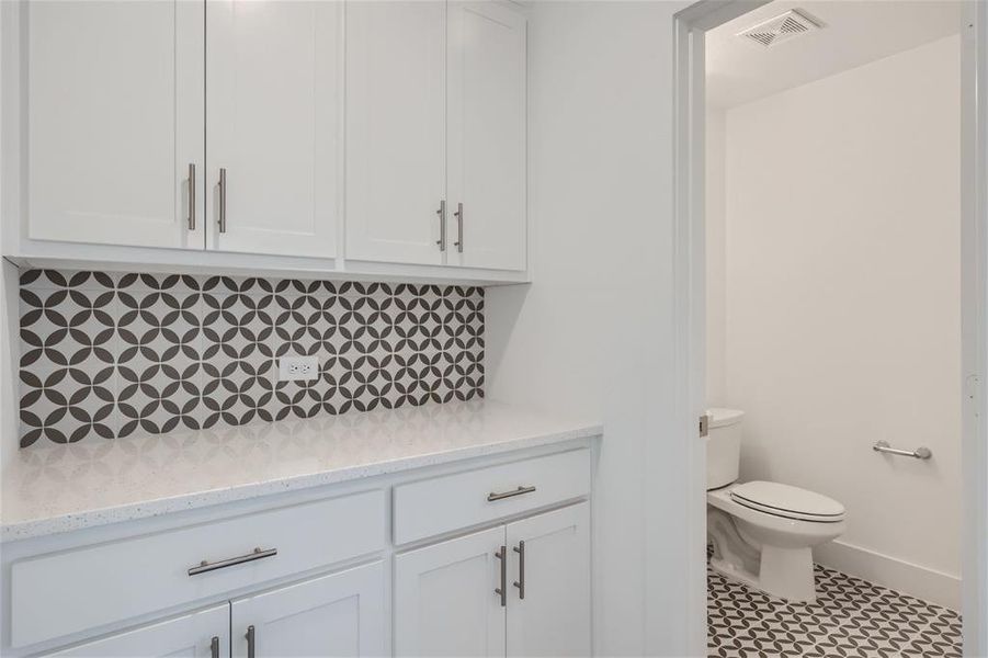 Bathroom featuring tile flooring, toilet, and vanity