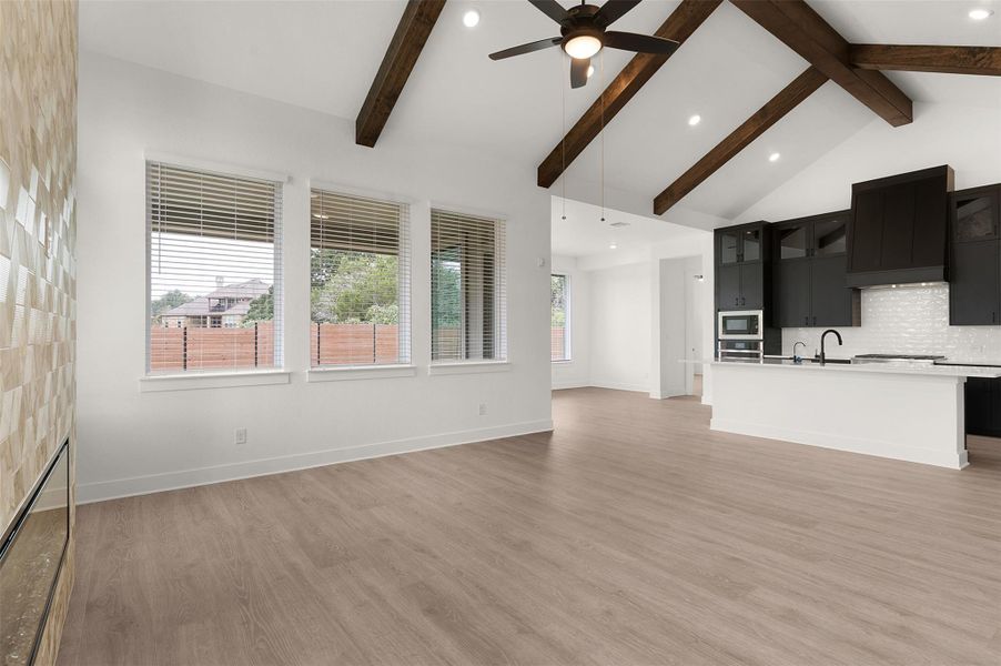 Unfurnished living room featuring light wood-type flooring, a ceiling fan, and recessed lighting