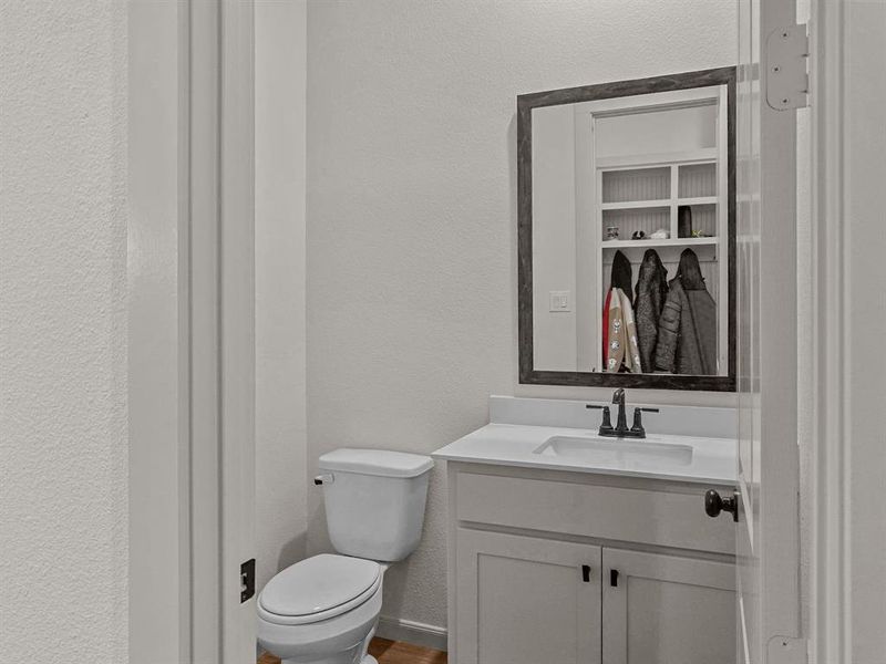 Half Bathroom with toilet and vanity