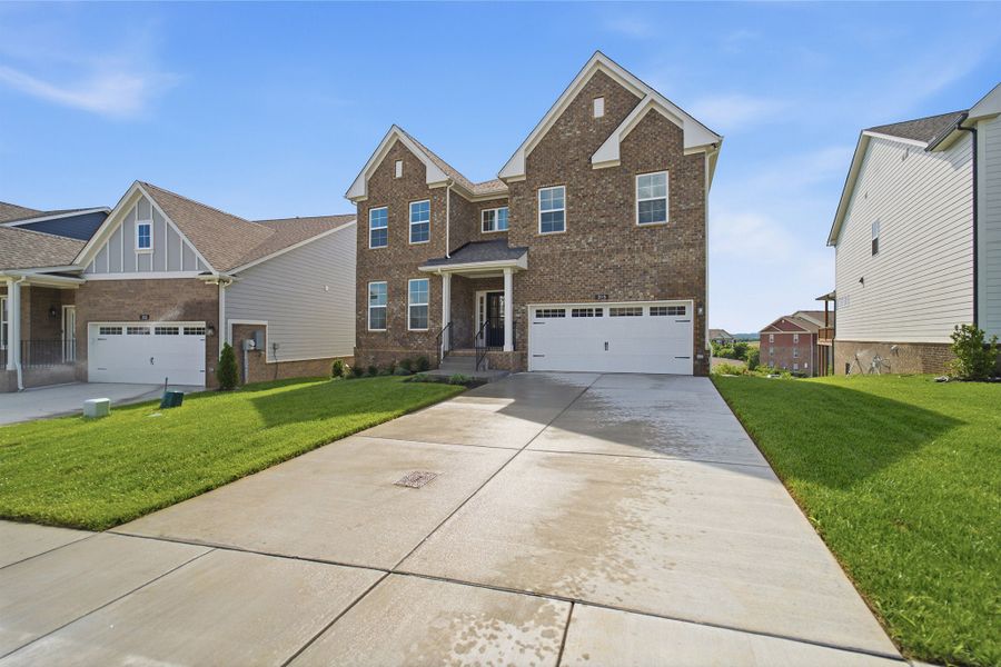 Front exterior of a new home in McCain's Station, Gallatin, TN, highlighting curb appeal (Image 2). Front exterior of a new home in McCain's Station, Gallatin, TN, highlighting curb appeal (Image 2).