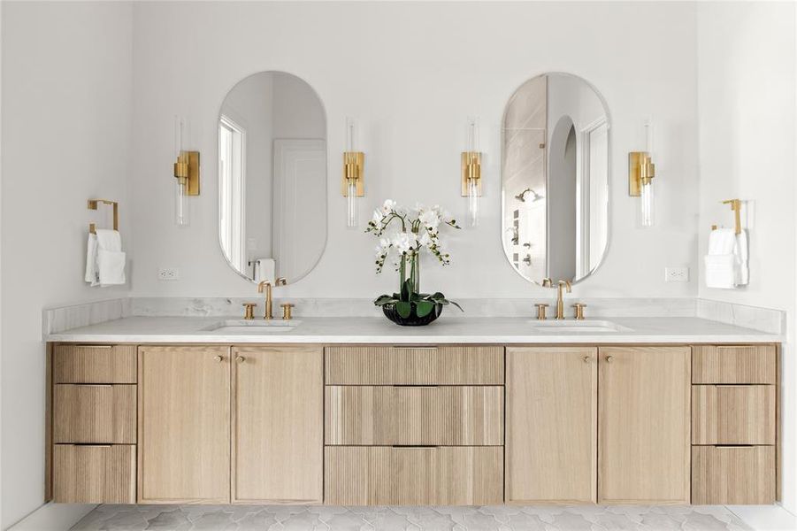 Double vanity featuring light wood-finish cabinetry and a white countertop