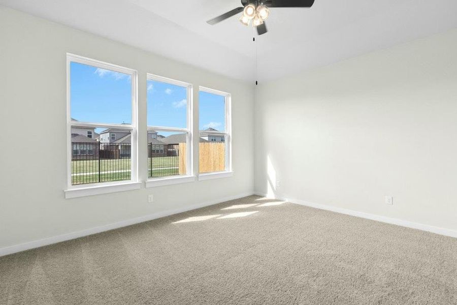 Unfurnished room featuring carpet flooring and a ceiling fan