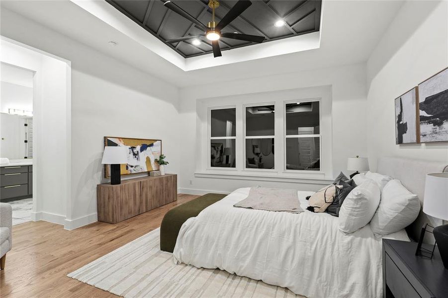 Bedroom with baseboards, ceiling fan, light wood finished floors, and ensuite bathroom