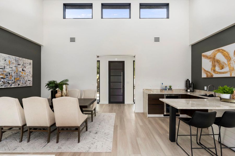 Dining space featuring wine cooler and light wood-style flooring