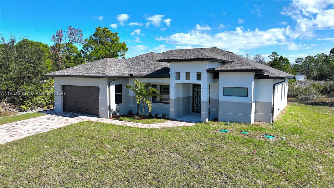 Front exterior of a new home in , Lehigh Acres, FL, highlighting curb appeal (Image 28). Front exterior of a new home in , Lehigh Acres, FL, highlighting curb appeal (Image 28).