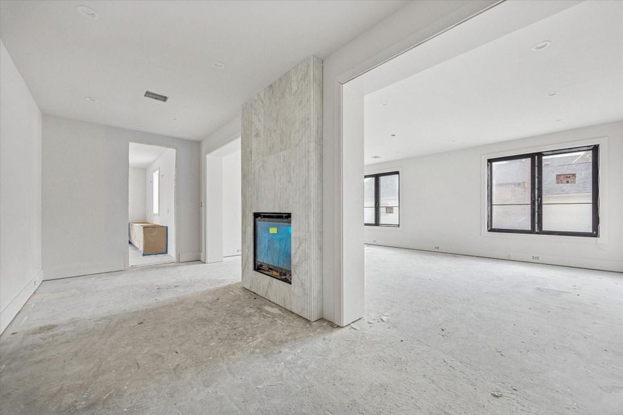 Large primary suite with fireplace encased with fluted marble, sitting area, and large bedroom. Large primary suite with fireplace encased with fluted marble, sitting area, and large bedroom.