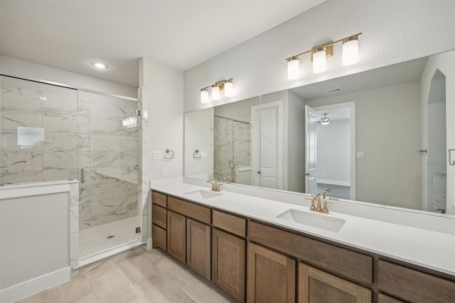 Bathroom with tile patterned floors, vanity, ceiling fan, and a shower with shower door