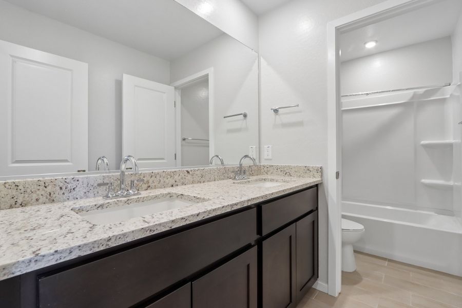 A bathroom with a marble countertop.