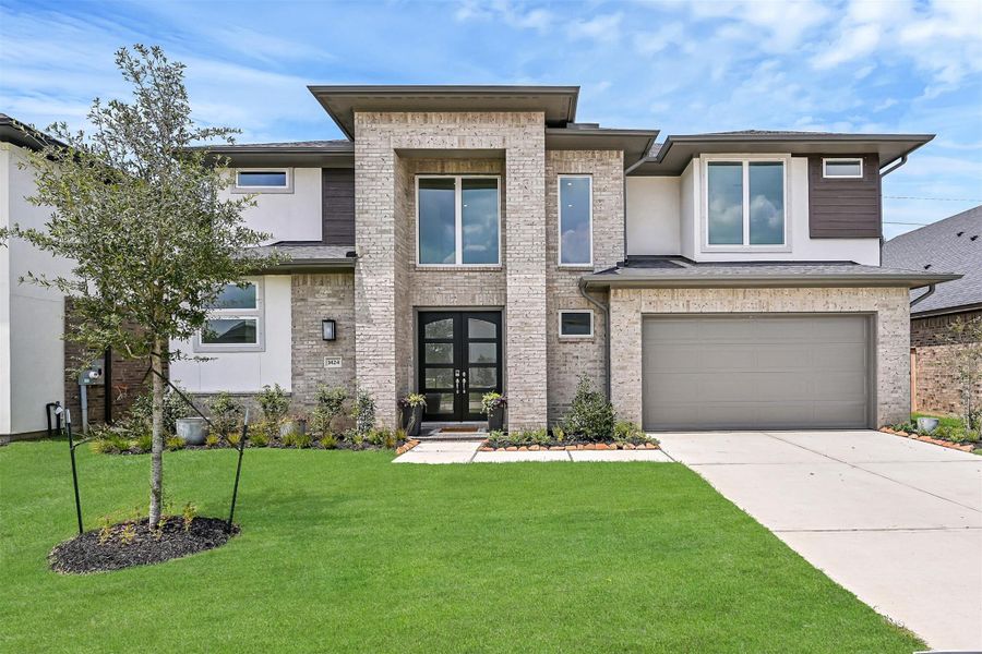 Front exterior of a new home in Avalon at Friendswood 60s, Friendswood, TX, highlighting curb appeal (Image 23). Front exterior of a new home in Avalon at Friendswood 60s, Friendswood, TX, highlighting curb appeal (Image 23).