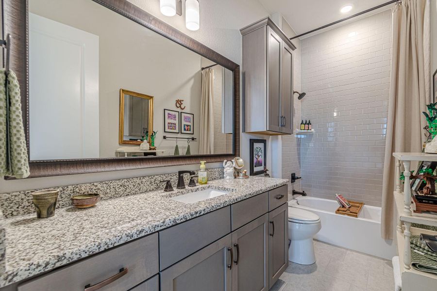 Bathroom with vanity, shower / bath combo with shower curtain, and recessed lighting