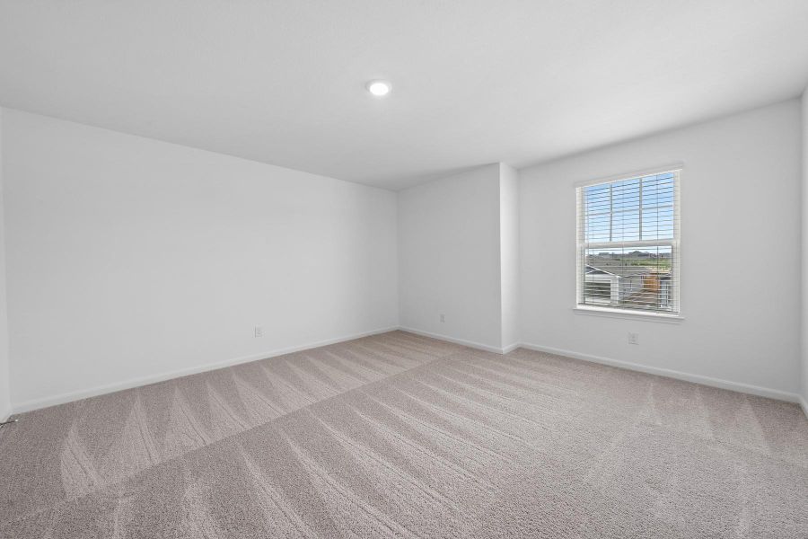 Spare room with light colored carpet and baseboards
