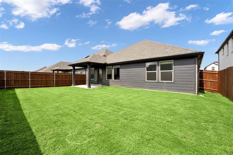Back of house featuring a patio area, roof with shingles, and a fenced backyard Back of house featuring a patio area, roof with shingles, and a fenced backyard