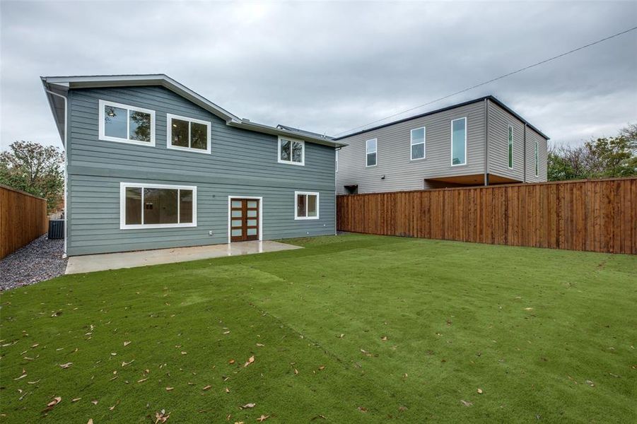 Rear view of house featuring a patio area, a fenced backyard, and french doors