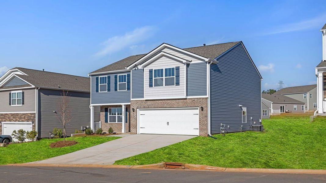 Front exterior of a new home in Woodglen, Piedmont, SC, highlighting curb appeal (Image 2). Front exterior of a new home in Woodglen, Piedmont, SC, highlighting curb appeal (Image 2).