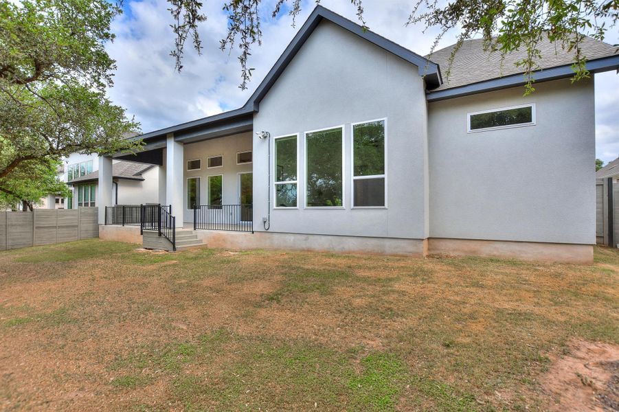 Back of house with a patio area and stucco siding