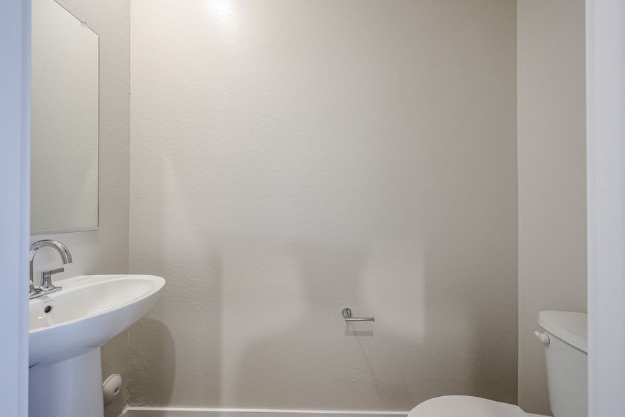 A bathroom with a sink and toilet. A bathroom with a sink and toilet.