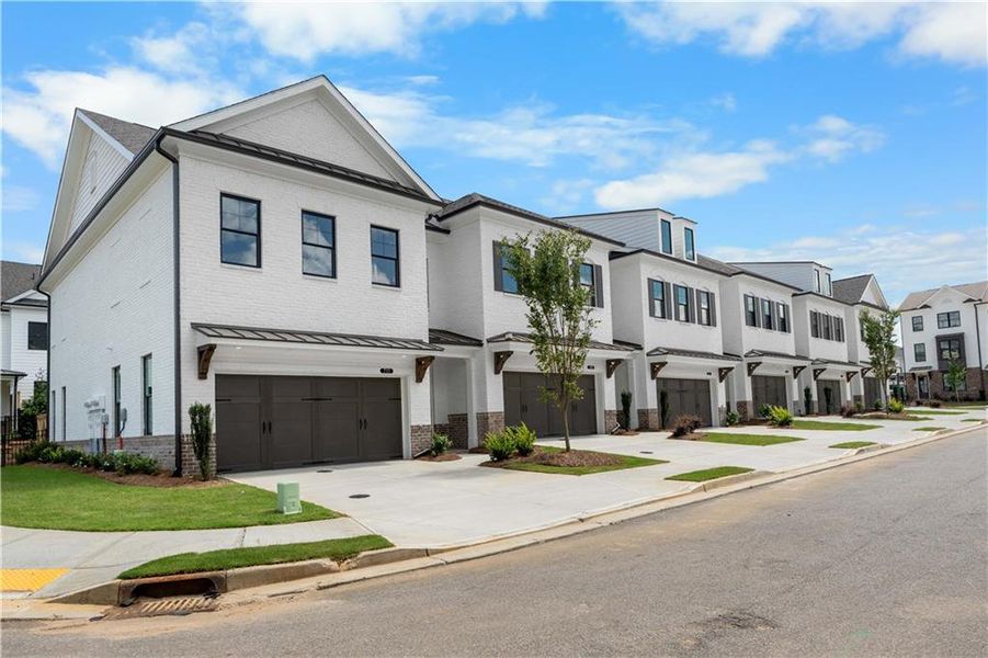 Front exterior of a new home in Millcroft Townhomes, Buford, GA, highlighting curb appeal (Image 1).
