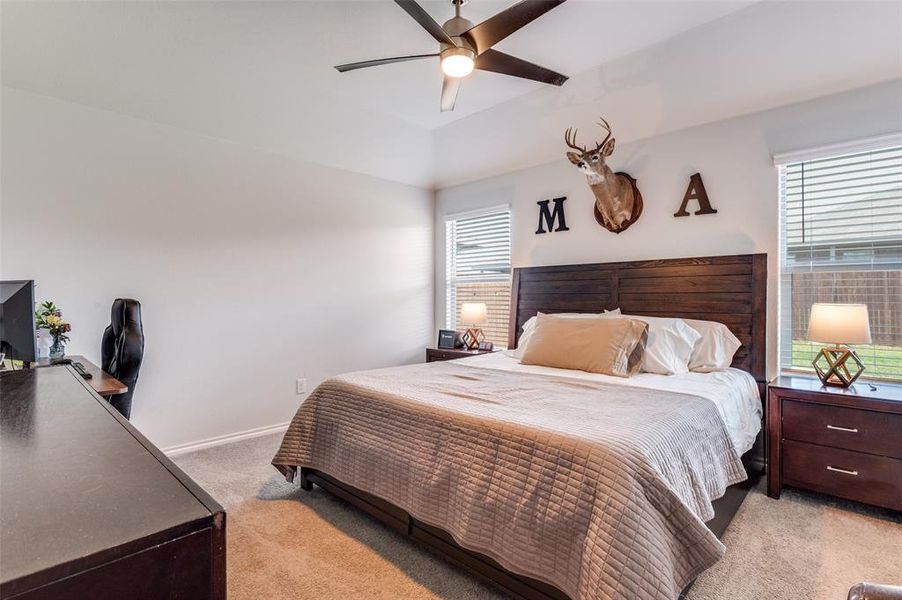 Bedroom featuring light carpet, and ceiling fan