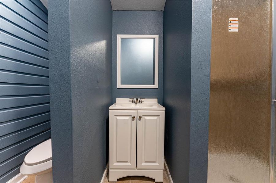 Bathroom with a shower, vanity, and toilet Bathroom with a shower, vanity, and toilet
