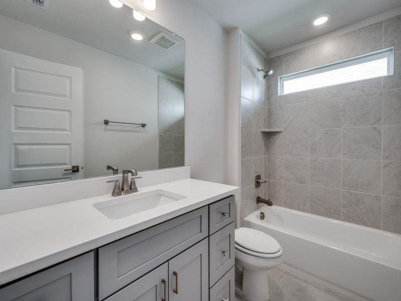 Friends and family will feel right at home in either of the guest baths in this dream home!