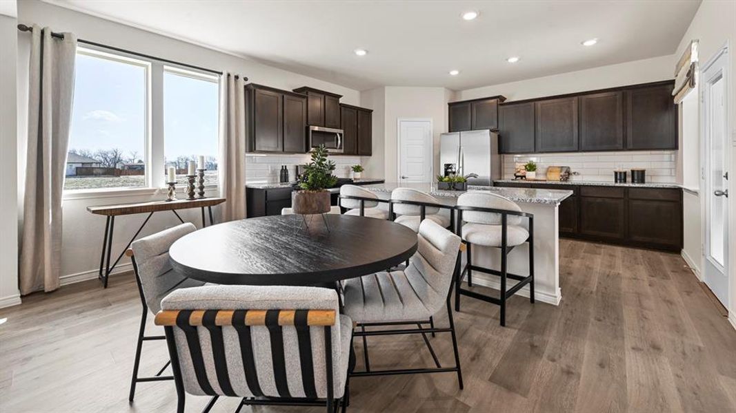 Dining room featuring light wood finished floors and recessed lighting Dining room featuring light wood finished floors and recessed lighting