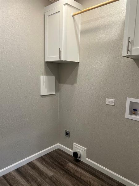 Laundry area with dark wood-style floors, electric dryer hookup, a textured wall, and hookup for a washing machine