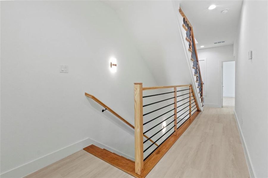 Stairs featuring wood finished floors and recessed lighting Stairs featuring wood finished floors and recessed lighting
