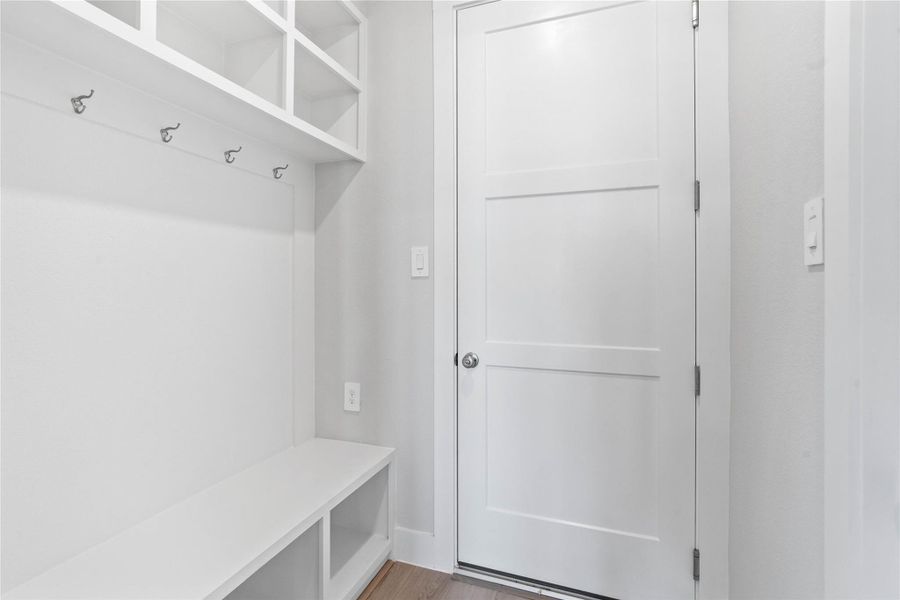 The ultimate in organization and cleanliness—a dedicated mudroom designed to manage daily life with ease. This highly desirable space serves as the perfect "drop zone" between the outdoors and your main living areas, helping to keep your home tidy and clutter-free.