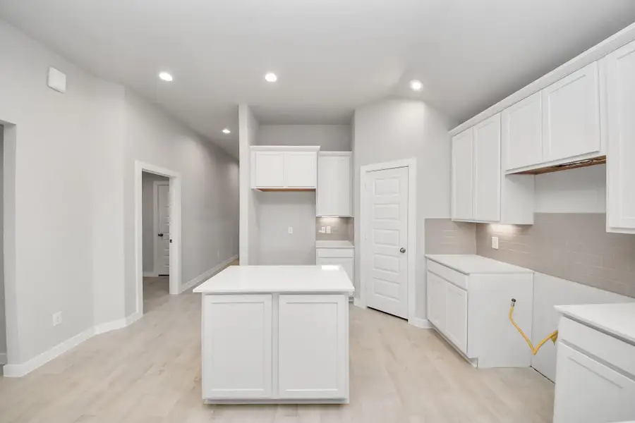 Step into a dream realized with this generously spacious kitchen! A massive granite island takes center stage, complemented by high ceilings and soft-close cabinets. Sample photo of completed home with similar floor plan. Actual colors and selections may vary. Step into a dream realized with this generously spacious kitchen! A massive granite island takes center stage, complemented by high ceilings and soft-close cabinets. Sample photo of completed home with similar floor plan. Actual colors and selections may vary.