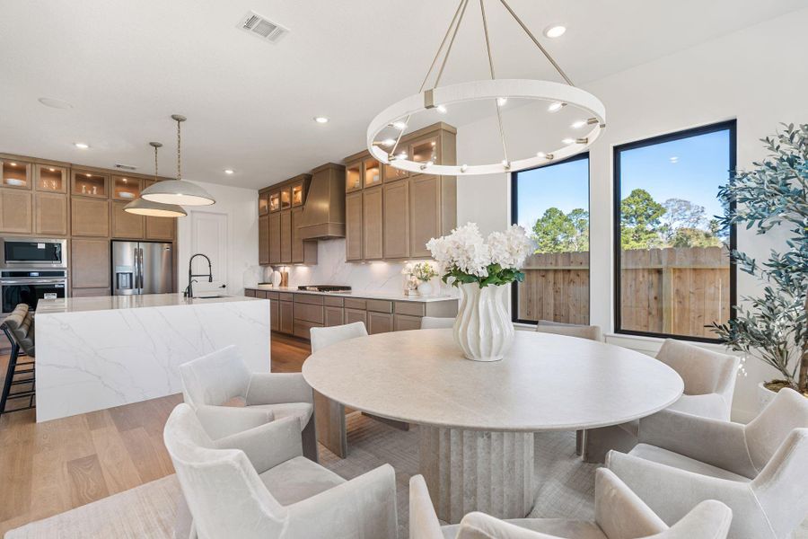 Bright open-concept dining area is adjacent to the gourmet kitchen