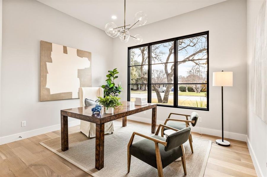 A dedicated office positioned at the front of the home, offering a quiet, polished space for focused work or meetings, separate from the main living areas while still feeling connected to the flow of the house