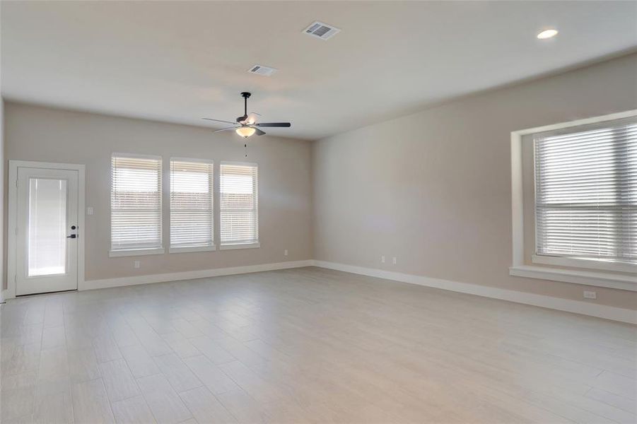 Unfurnished room with ceiling fan and light hardwood / wood-style flooring