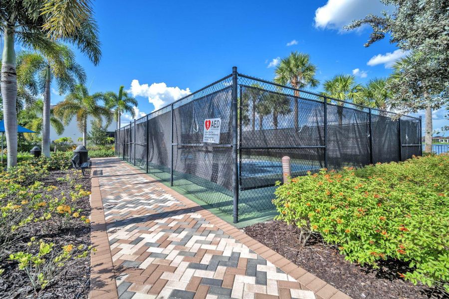 Front exterior of a new home in , Ave Maria, FL, highlighting curb appeal (Image 1).