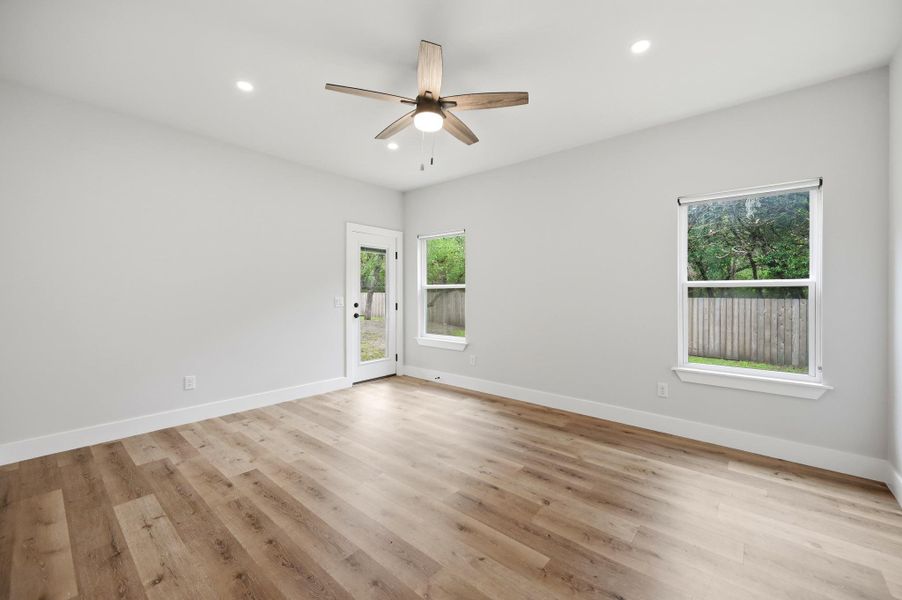 Recessed lighting and a stylish ceiling fan complement durable hardwood flooring throughout this versatile living space. Recessed lighting and a stylish ceiling fan complement durable hardwood flooring throughout this versatile living space.